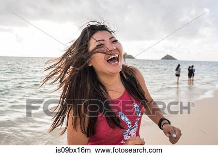 Woman swinging hair, Lanikai Beach, Oahu, Hawaii View Large Photo Image Picture - Woman swinging hair, Lanikai Beach, Oahu, Hawaii. Fotosearch