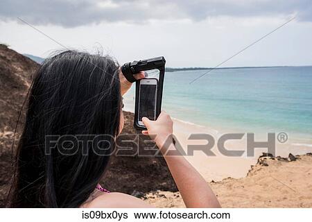 Woman taking photo on beach, Makena Beach, Maui, Hawaii View Large Photo Image Stock Photograph - Woman taking photo on beach, Makena Beach, Maui, Hawaii. Fotosearch