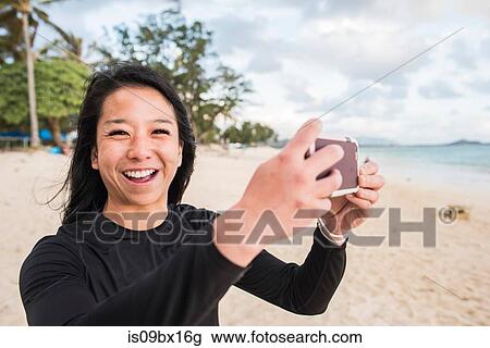 Woman taking photo on Kailua Beach, Oahu, Hawaii View Large Photo Image Stock Image - Woman taking photo on Kailua Beach, Oahu, Hawaii. Fotosearch