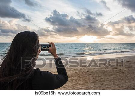 Woman taking photo on Kailua Beach, Oahu, Hawaii View Large Photo Image Stock Image - Woman taking photo on Kailua Beach, Oahu, Hawaii. Fotosearch