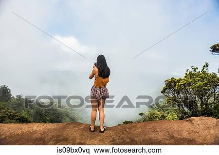 Woman taking photograph of mist, Waimea Canyon, Kauai, Hawaii View Large Photo Image Stock Photography - Woman taking photograph of mist, Waimea Canyon, Kauai, Hawaii. Fotosearch