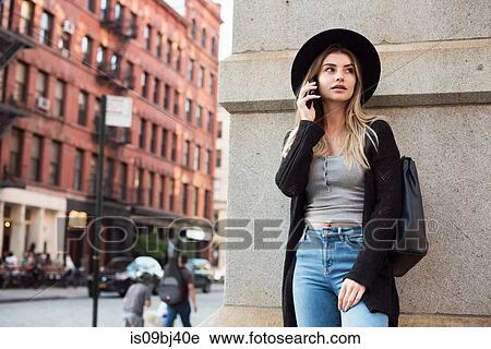 Stock Image - Woman using mobile phone, New York, USA. Fotosearch