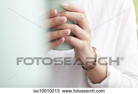 Stock Image - Woman using reusable coffee cup. Fotosearch