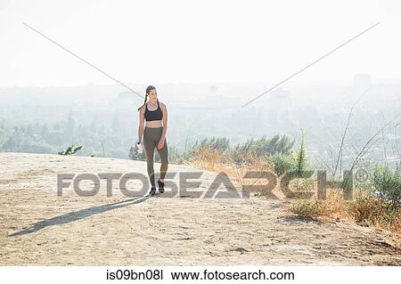 Woman walking on hilltop View Large Photo Image Stock Image - Woman walking on hilltop. Fotosearch
