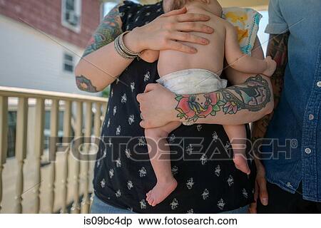 Stock Photography - Woman with baby boy in arms. Fotosearch