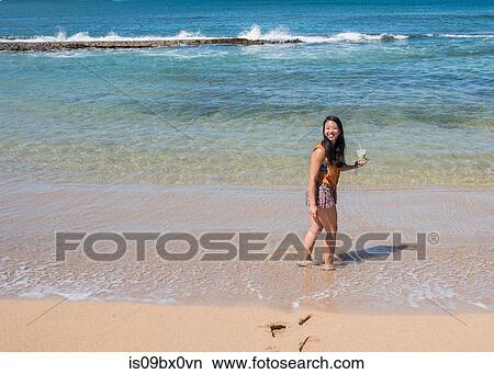 Woman with fruit juice on beach, Waimea Canyon, Kauai, Hawaii View Large Photo Image Picture - Woman with fruit juice on beach, Waimea Canyon, Kauai, Hawaii. Fotosearch