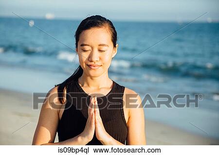 Woman with palms pressed together on beach View Large Photo Image Stock Image - Woman with palms pressed together on beach. Fotosearch