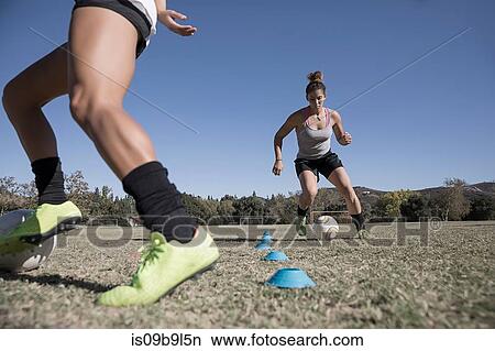 Women dribbling footballs View Large Photo Image Picture - Women dribbling footballs. Fotosearch