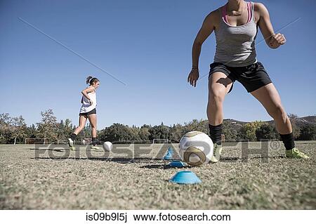 Women dribbling footballs View Large Photo Image Stock Image - Women dribbling footballs. Fotosearch