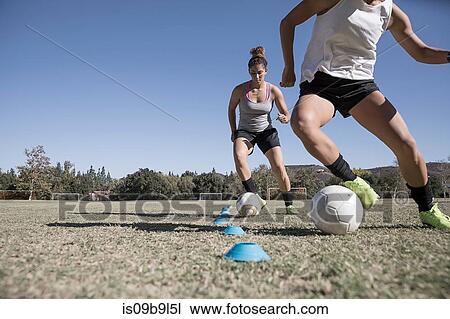 Women dribbling footballs View Large Photo Image Stock Image - Women dribbling footballs. Fotosearch