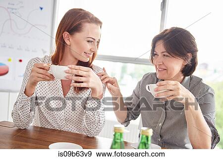 Stock Photo - Women having coffee break together. Fotosearch