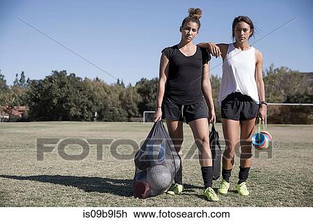 Women on football pitch carrying footballs in net sack View Large Photo Image Stock Image - Women on football pitch carrying footballs in net sack. Fotosearch