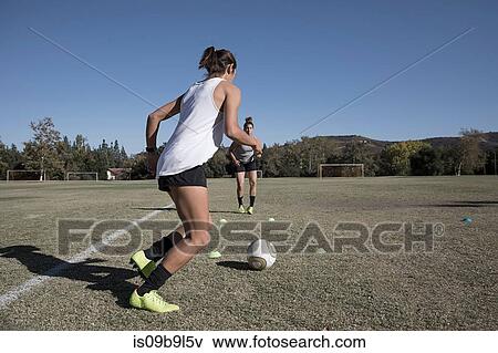 Women on football pitch playing football View Large Photo Image Stock Photo - Women on football pitch playing football. Fotosearch