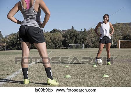 Women on football pitch playing football View Large Photo Image Stock Photo - Women on football pitch playing football. Fotosearch