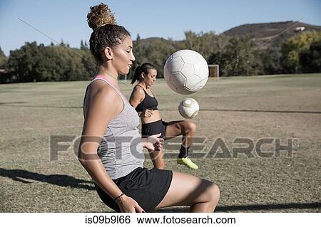 Women on football pitch playing football View Large Photo Image Stock Photograph - Women on football pitch playing football. Fotosearch