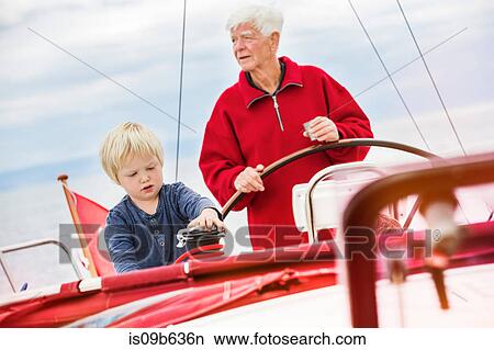 Young boy with great grandfather on sailing boat, Geneva, Switzerland, Europe View Large Photo Image Picture - Young boy with great grandfather on sailing boat, Geneva, Switzerland, Europe. Fotosearch