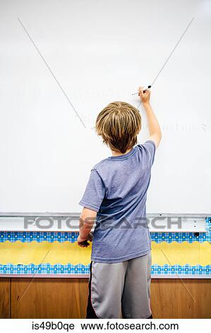 Young boy writing on whiteboard, rear view View Large Photo Image Stock Image - Young boy writing on whiteboard, rear view. Fotosearch
