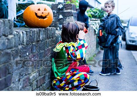 Young boys dressed in halloween costume, beside house, trick or treating View Large Photo Image Stock Photography - Young boys dressed in halloween costume, beside house, trick or treating. Fotosearch