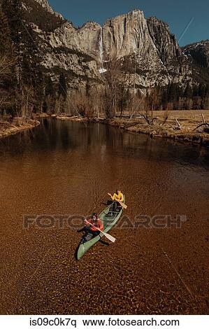 Young canoeing couple canoeing on river, high angle view, Yosemite Village, California, USA View Large Photo Image Stock Photography - Young canoeing couple canoeing on river, high angle view, Yosemite Village, California, USA. Fotosearch