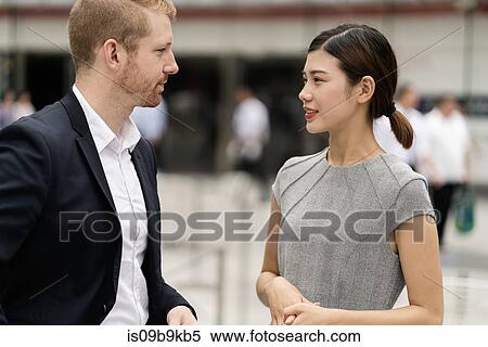 Stock Photography - Young city businessman and woman meeting outdoors. Fotosearch