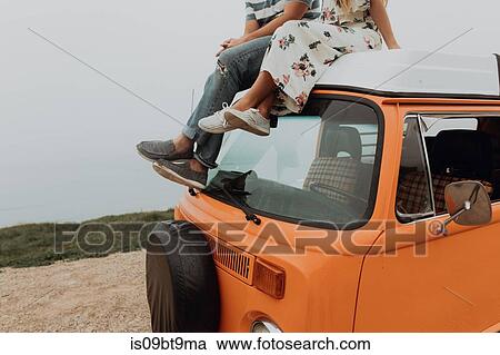 Young couple on top of recreational vehicle at coastal roadside, cropped, Jalama, California, USA View Large Photo Image Stock Image - Young couple on top of recreational vehicle at coastal roadside, cropped, Jalama, California, USA. Fotosearch