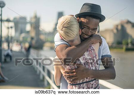Young couple outdoors, hugging View Large Photo Image Stock Photography - Young couple outdoors, hugging. Fotosearch