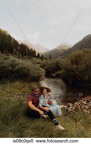 Young couple sitting by rural river, Mineral King, California, USA View Large Photo Image Stock Image - Young couple sitting by rural river, Mineral King, California, USA. Fotosearch