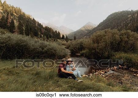 Young couple sitting by rural river, Mineral King, California, USA View Large Photo Image Stock Image - Young couple sitting by rural river, Mineral King, California, USA. Fotosearch
