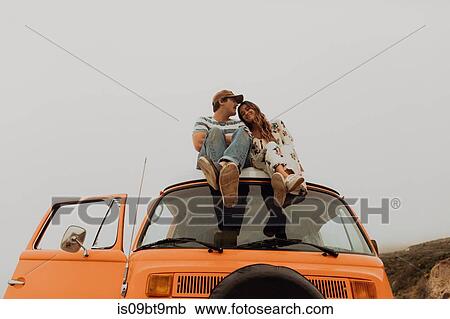 Young couple sitting on top of recreational vehicle, Jalama, California, USA View Large Photo Image Stock Image - Young couple sitting on top of recreational vehicle, Jalama, California, USA. Fotosearch