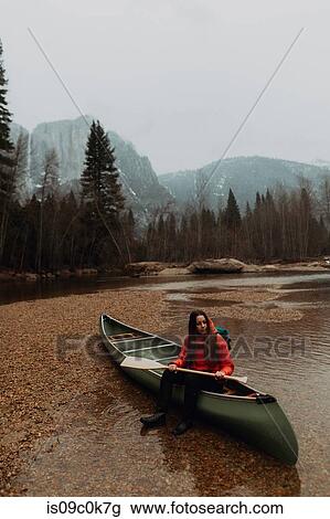 Young female canoeist sitting on canoe in river, Yosemite Village, California, USA View Large Photo Image Stock Image - Young female canoeist sitting on canoe in river, Yosemite Village, California, USA. Fotosearch