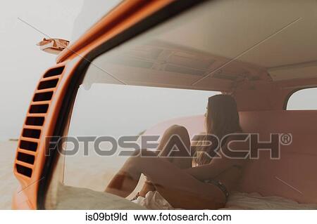 Young female surfer looking out from recreational vehicle at beach, Jalama, California, USA View Large Photo Image Stock Image - Young female surfer looking out from recreational vehicle at beach, Jalama, California, USA. Fotosearch