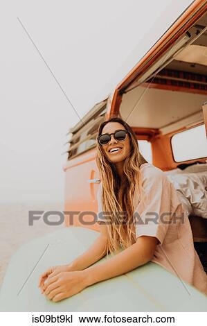 Young female surfer sitting on recreational vehicle on beach, Jalama, Ventura, California, USA View Large Photo Image Stock Image - Young female surfer sitting on recreational vehicle on beach, Jalama, Ventura, California, USA. Fotosearch
