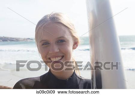 Young female surfer with surfboard on beach, portrait, Cape Town, Western Cape, South Africa View Large Photo Image Stock Photo - Young female surfer with surfboard on beach, portrait, Cape Town, Western Cape, South Africa. Fotosearch
