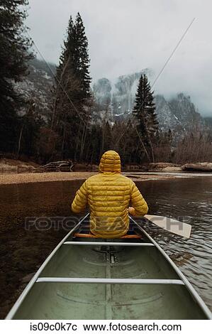 Young male canoeist rowing canoe on river, rear view, Yosemite Village, California, USA View Large Photo Image Stock Image - Young male canoeist rowing canoe on river, rear view, Yosemite Village, California, USA. Fotosearch