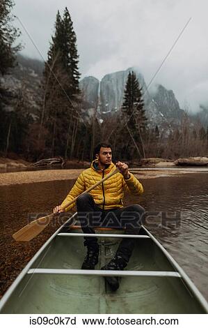 Young male canoeist rowing canoe on river, Yosemite Village, California, USA View Large Photo Image Stock Image - Young male canoeist rowing canoe on river, Yosemite Village, California, USA. Fotosearch