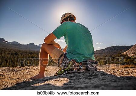 Young male climber sitting on top of rock formation, Tuolumne Meadows, upper part of the Yosemite National Park, California, USA View Large Photo Image Stock Image - Young male climber sitting on top of rock formation, Tuolumne Meadows, upper part of the Yosemite National Park, California, USA. Fotosearch