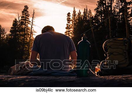 Young male hiker taking a break at sunset, Tuolumne Meadows, upper part of the Yosemite National Park, California, USA View Large Photo Image Stock Image - Young male hiker taking a break at sunset, Tuolumne Meadows, upper part of the Yosemite National Park, California, USA. Fotosearch