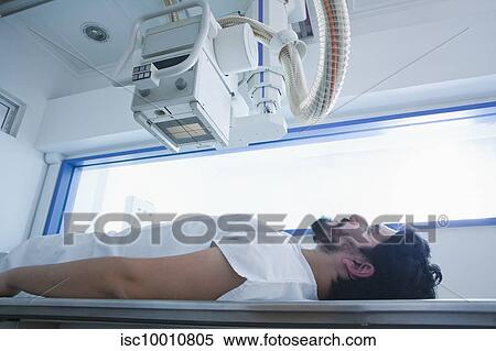 Young male patient having a CT scan in radiology department, side view View Large Photo Image Stock Photography - Young male patient having a CT scan in radiology department, side view. Fotosearch
