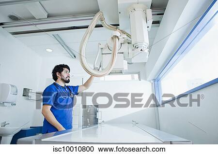 Young male radiographer preparing X-ray machine in radiology department View Large Photo Image Stock Image - Young male radiographer preparing X-ray machine in radiology department. Fotosearch