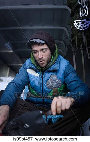 Young male rock climber 0eparing climbing equipment in camper van View Large Photo Image Stock Photo - Young male rock climber 0eparing climbing equipment in camper van. Fotosearch