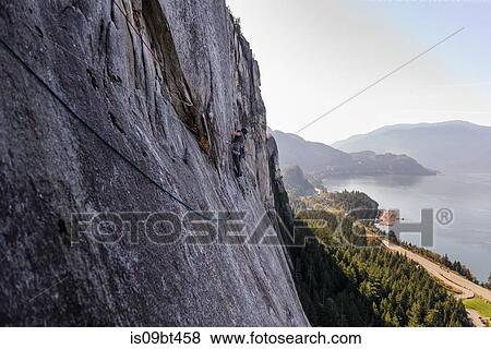 Young male rock climber climbing rock face, elevated view, The Chief, Squamish, British Columbia, Canada View Large Photo Image Stock Photo - Young male rock climber climbing rock face, elevated view, The Chief, Squamish, British Columbia, Canada. Fotosearch