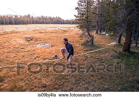 Young man 1acticing on slack line, Tuolumne Meadows, upper part of the Yosemite National Park, California, USA View Large Photo Image Stock Image - Young man 1acticing on slack line, Tuolumne Meadows, upper part of the Yosemite National Park, California, USA. Fotosearch