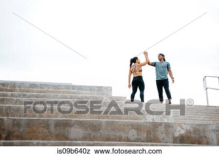 Young man and woman at top of steps, celebrating workout, South Point Park, Miami Beach, Florida, USA View Large Photo Image Stock Photo - Young man and woman at top of steps, celebrating workout, South Point Park, Miami Beach, Florida, USA. Fotosearch