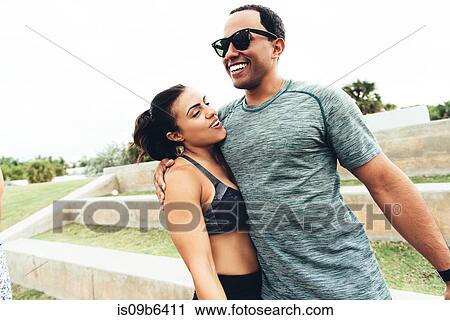 Young man and woman wearing sports clothing, outdoors, hugging, South Point Park, Miami Beach, Florida, USA View Large Photo Image Stock Image - Young man and woman wearing sports clothing, outdoors, hugging, South Point Park, Miami Beach, Florida, USA. Fotosearch