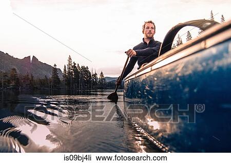 Young man canoeing on Echo Lake, High Sierras, California, USA View Large Photo Image Stock Image - Young man canoeing on Echo Lake, High Sierras, California, USA. Fotosearch