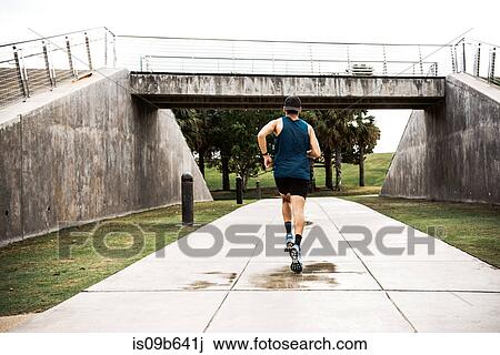 Young man exercising outdoors, running, rear view, South Point Park, Miami Beach, Florida, USA View Large Photo Image Stock Image - Young man exercising outdoors, running, rear view, South Point Park, Miami Beach, Florida, USA. Fotosearch