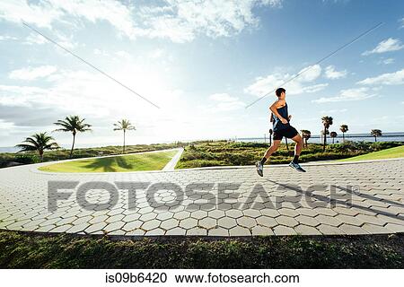 Young man exercising, running outdoors, South Point Park, Miami Beach, Florida, USA View Large Photo Image Stock Image - Young man exercising, running outdoors, South Point Park, Miami Beach, Florida, USA. Fotosearch