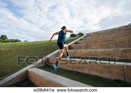 Young man exercising, running outdoors, leaping up steps, South Point Park, Miami Beach, Florida, USA View Large Photo Image Stock Photo - Young man exercising, running outdoors, leaping up steps, South Point Park, Miami Beach, Florida, USA. Fotosearch