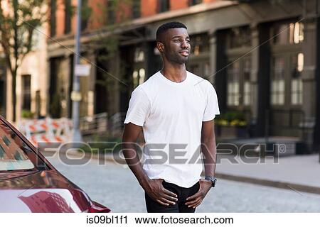 Young man in streets of New York, US View Large Photo Image Stock Image - Young man in streets of New York, US. Fotosearch
