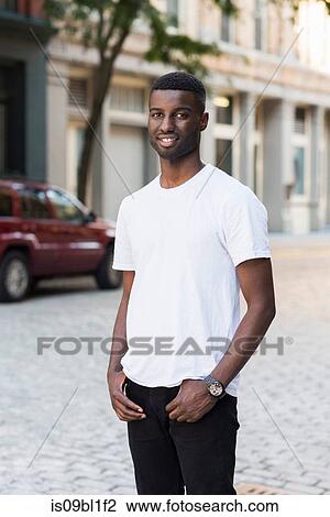 Stock Image - Young man in streets of New York, US. Fotosearch